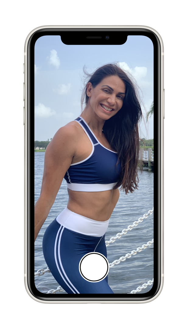 iPhone with camera app open taking an image of a fitness model at the beach in Florida.